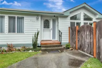 inviting entry with concrete patio, and access to the back yard.