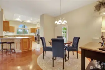 view from the hall to the living, dining and kitchen all cohesively flow together.