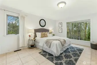 Spacious primary bedroom with abundant natural light.