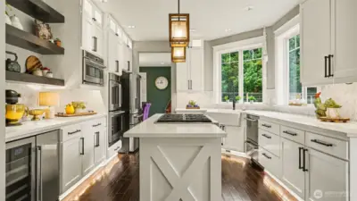 Quartz countertops, floating shelves, lighted cabinets & Cafe appliances make this a dream kitchen.