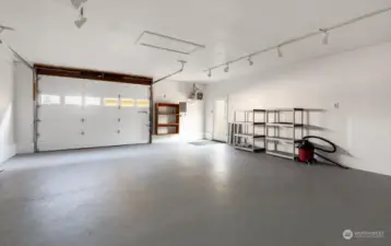 642 sq ft insulated shop with track lighting, cupboards, and large heater.