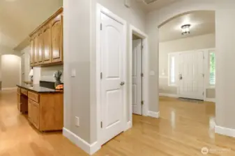 The main hall wraps around past the coat closet and winds to the kitchen