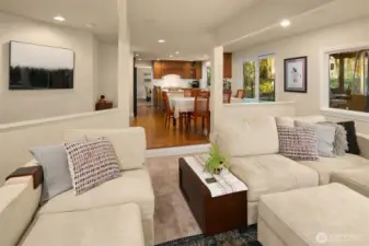 The kitchen opens to the spacious eating nook adjacent to the comfortable, sunken family room with a beautiful gas fireplace framed by large windows with plantation shutters and features built-in surround sound speakers.