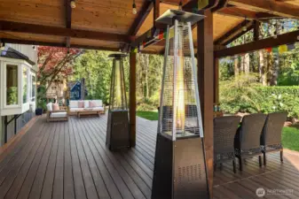 Off of the family room and kitchen space is the massive TimberTech deck with a covered area with outdoor speakers ~ perfect for Summer BBQ's, entertaining family or friends, lounging, and dining al fresco.