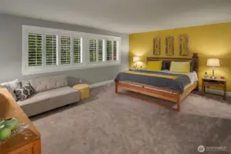 The lavish primary suite overlooks the back yard through plantation shutters.  Adjacent is the circular 5-piece en suite bathroom with heated floors, jetted tub and a large walk-in closet.