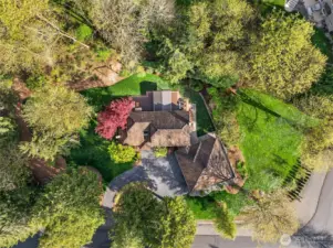 The home features a circular driveway, and the lot displays a beautiful color-contrast in the variety of trees and shrubs in the landscaping. Additional features and upgrades of the home include a commercial-grade cedar shake roof, wired for a generator, security system, and the Homeowners have had the crawlspace completely renovated.