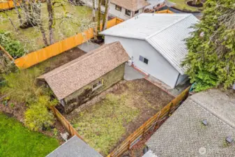 Back of the home. Outbuilding is included in this sale.