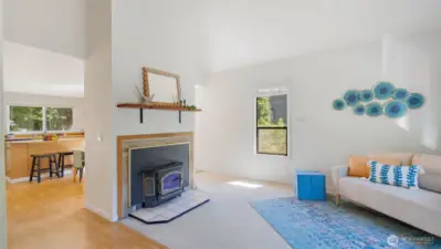 Just beyond the fireplace, the kitchen and dining area offer their own defined spaces while still feeling connected. It’s a layout that gives everyone room to breathe without losing that sense of togetherness.