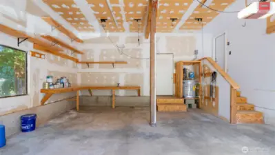 What an awesome garage! Extra-tall ceilings, a built-in workbench, and high shelving already in place make this space feel more like a workshop than just a place to park. Ready for projects, storage, or both!