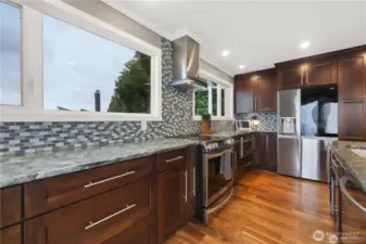 This chef's kitchen is a masterpiece of design and efficiency. It features high-end appliances, ample counter space, and custom cabinetry.