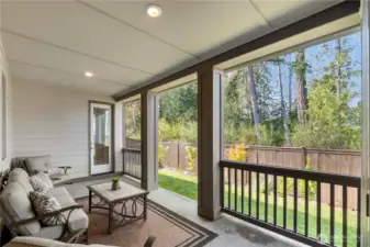 Extended covered patio with green belt view and private entrance to the primary suite