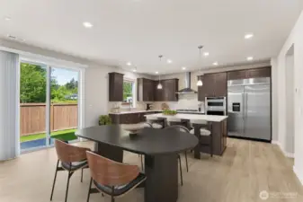 Spacious kitchen and informal dining area - virtually staged - showing a similar floorplan.