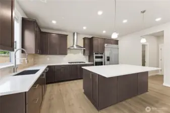 Well-appointed kitchen with gas cooktop, huge pantry adjacent to mud room just off the garage.  48" counter depth side-by-side refrigerator.  Plenty of space to entertain, showing similar plan!