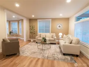 Craftsman style trim wraps the large walls, new LVP flooring sets a warm tone, and plenty of natural light floods in from the many windows here!