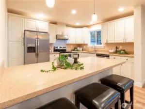 New cabinets with plenty of storage, stone countertops with a large breakfast bar! Stainless steel appliances and side by side fridge, modern stainless steel hood and plenty of counter space for all of your holiday baking needs!