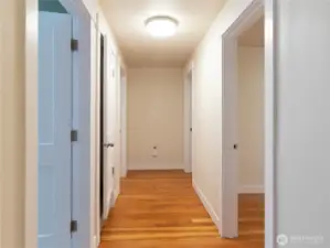 Classic douglas fir flooring throughout second story. Full guest bath is the first door on your left, both bedroom 1 and 2 are on your right, middle door leads to the third level with the flex room and last door on your left is the primary bedroom with bath en suite!