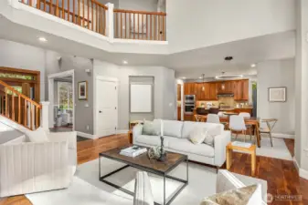 Light-filled open layout connecting living, dining, and kitchen spaces with warm wood accents and inviting design