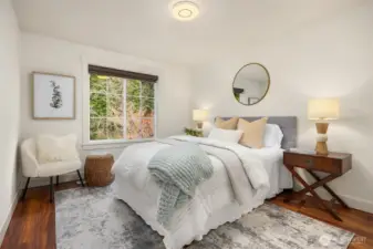 Comfortable secondary bedroom featuring hardwood floors and natural light.