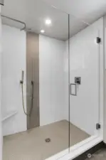 Filled with extensive designer tile and high end Delta hardware, this shower in the downstairs guest bedroom does not disappoint. The sleek glass swing door and radiant heated file flooring continues to showcase the details this home offers for the new owners.