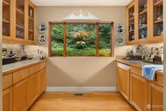 The open bar with glass and maple cabinetry.