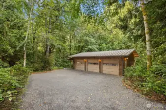 The detached 3-car garage is amazing! Featuring finished insulated walls, built-in storage and workbench.   There is also a finished slab and covered shed at end for additional storage options.