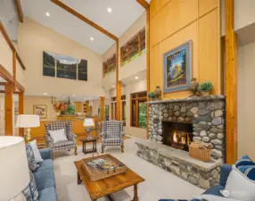 Center stage is this wood-burning river rock fireplace with raised hearth.