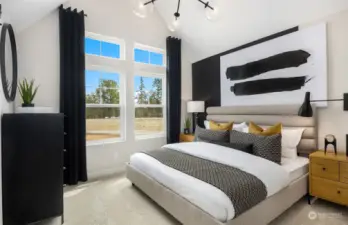 Primary bedroom with vaulted ceilings