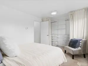 Spacious bedroom with custom closet organizer.