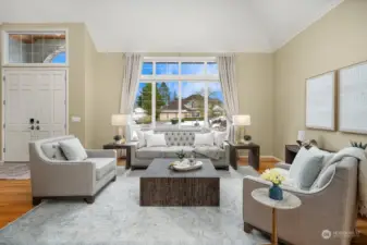 Extended hardwoods and beautiful windows grace the living room.