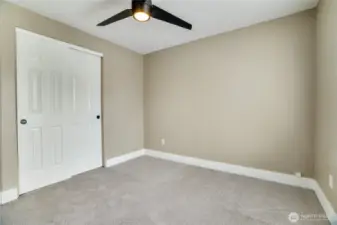 This bedroom not only offers refreshed charm with fresh paint, new carpet, and updated millwork, but also includes a generous closet, providing ample storage to keep everything organized and accessible