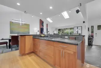 Large island with custom cabinets and granite counter tops. 5 burner gas cooktop.  Perfect for entertaining.