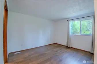 Main level bedroom - bathroom is off to the left - window faces out to the driveway