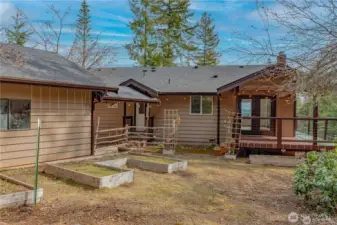 More garden space behind the home/garage with covered patio off the dining space that wraps around to the spacious deck to take advantage of those incredible Hood Canal and moutntain Views