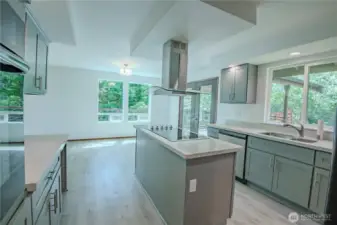 Spacious kitchen island with stovetop and overhead vent
