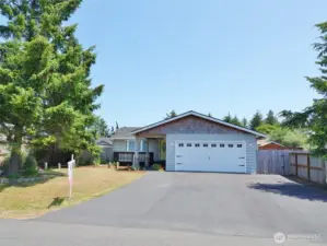 Large asphalt driveway leads to the 2-car Garage.