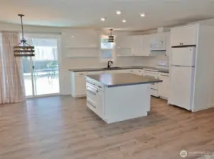 Dining Area and Kitchen w/ Slider to the Rear Deck and Fenced Backyard.