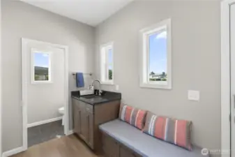 Mud room with half bathroom.