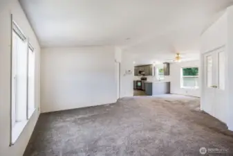 Bright and spacious living room with open-concept layout, perfect for seamless living and entertaining.