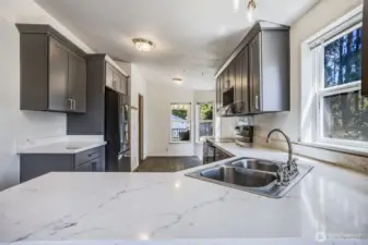 Featuring granite countertops, modern cabinetry, and ideal workspace for the home chef!
