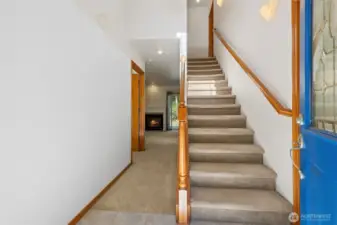 Open rail stairs lead to the 2nd floor and 3 bedrooms