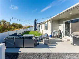 oversized patio with fenced backyard