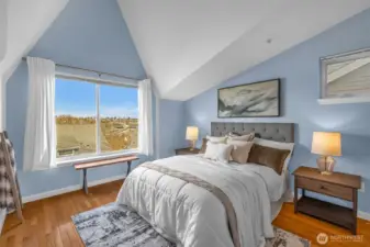 Primary bedroom with vaulted ceilings