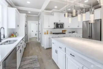 Looking through kitchen into laundry room. Garage beyond.