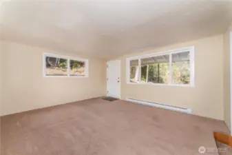Large and bright living room with covered deck off the back of the home