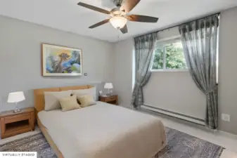 Primary bedroom overlooks the serene and private backyard.