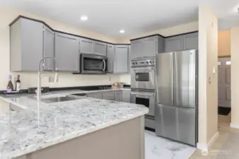 Step into this newly warm and inviting remodeled kitchen, featuring stunning new granite countertops, sleek stainless steel appliances, a brand-new cooktop and a double oven ready for all your gourmet cooking.
