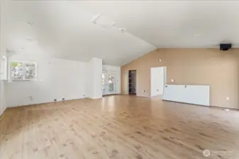 Kitchen to the left and living room, looking towards entrance.