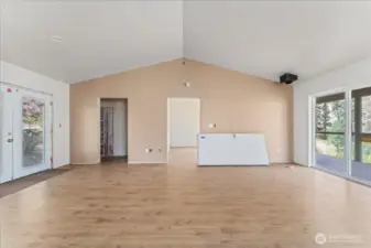 From living room, small bathroom to the left and primary bedroom straight ahead.