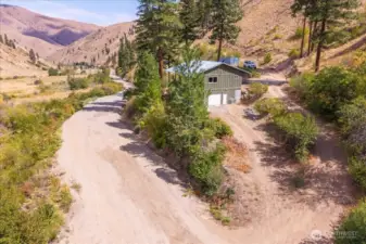 Another view showing the cabin, the road, and the driveway.
