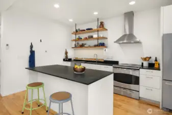 The updated induction range and Zephyr hood compliment this open design.